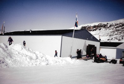A big pile of snow beside the co-op store in Salluit is a draw to kids in the spring of 1996. (PHOTO BY JANE GEORGE)