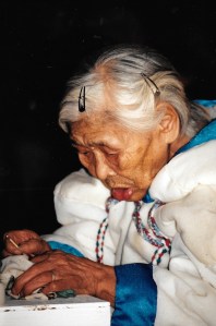 Rosie Iqallijuq, 91, lights the qulliq at the Return of the Sun ceremony in Igloolik in 1997. (PHOTO BY JANE GEORGE)