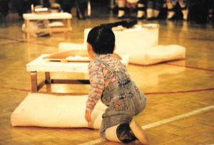 A boy looks at the qulliit lit at 1997's Return of the Sun ceremony in Igloolik. (PHOTO BY JANE GEORGE)