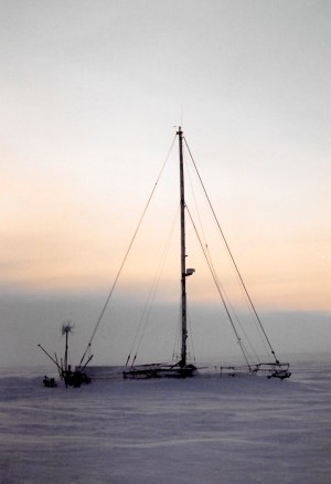 A sailboat, frozen in the sea ice outside Igloolik, is home to two sailors from France during the winter of 1997. (PHOTO BY JANE GEORGE)