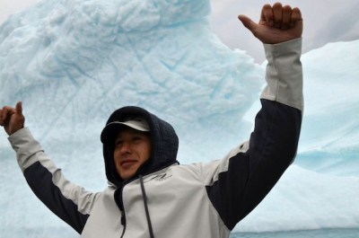 NHL player Jordin Tootoo stands in front of an iceberg in Qikiqtarjuaq in 2013 (PHOTO BY DAVID MURPHY/NUNATSIAQ NEWS)