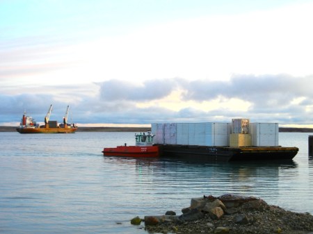 A tug brings containers to shore in Cambridge Bay. (PHOTO BY JANE GEORGE)